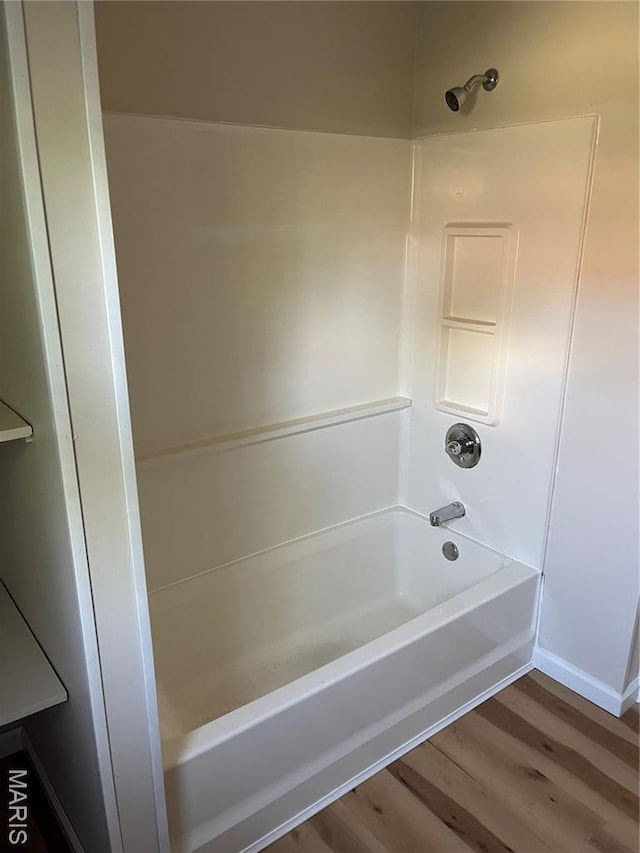 1032 W Pearl St, Staunton, IL 62088 - bathroom featuring wood finished floors and tub / shower combination