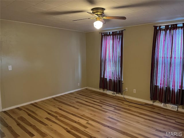 1032 W Pearl St, Staunton, IL 62088 - unfurnished room with a ceiling fan, light wood finished floors, and plenty of natural light