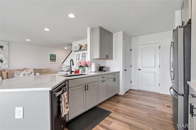 130 Baycrest Ct, Saint Charles, MO 63301 - kitchen with freestanding refrigerator, dishwasher, light wood-type flooring, open floor plan, and a peninsula