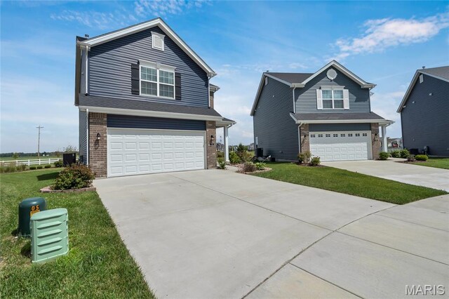 130 Baycrest Ct, Saint Charles, MO 63301 - view of front of home featuring brick siding, a garage, concrete driveway, and a front lawn