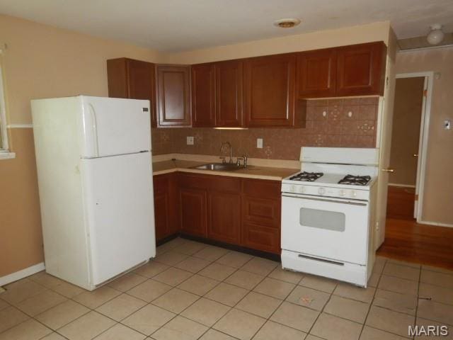 10246 Dacey Dr, Saint Louis, MO 63136 - kitchen with white appliances, light countertops, backsplash, and light tile patterned floors