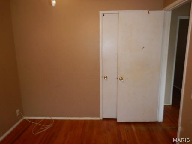 10246 Dacey Dr, Saint Louis, MO 63136 - unfurnished bedroom with wood finished floors and baseboards