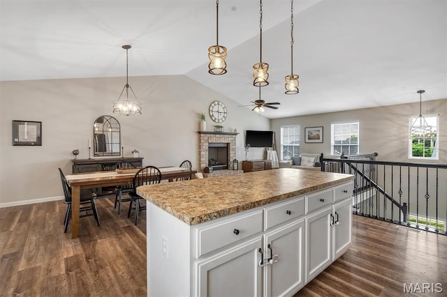 1424 Cortez Dr, Hillsboro, MO 63050 - kitchen featuring a ceiling fan, lofted ceiling, dark wood finished floors, a brick fireplace, and a center island