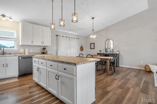1424 Cortez Dr, Hillsboro, MO 63050 - kitchen featuring stainless steel dishwasher, dark wood-style flooring, vaulted ceiling, a center island, and light countertops