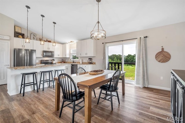 1424 Cortez Dr, Hillsboro, MO 63050 - dining area with lofted ceiling, dark wood-style floors, and a chandelier