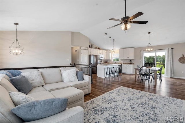 1424 Cortez Dr, Hillsboro, MO 63050 - living area with dark wood-style flooring, a ceiling fan, a chandelier, and high vaulted ceiling