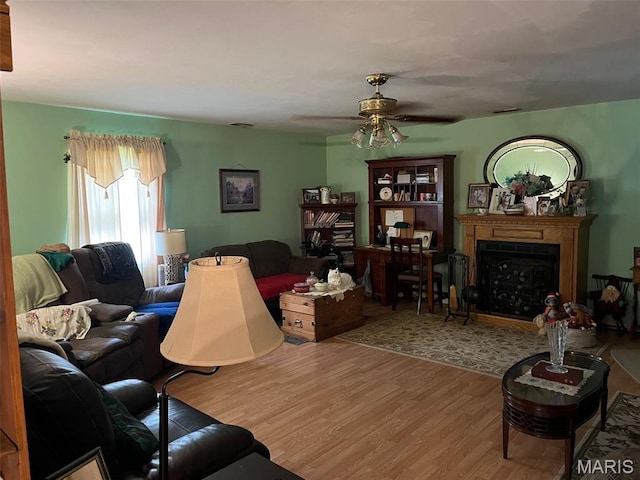 13688 State Highway U, Mineral Point, MO 63660 - living room featuring wood finished floors, a fireplace, and a ceiling fan