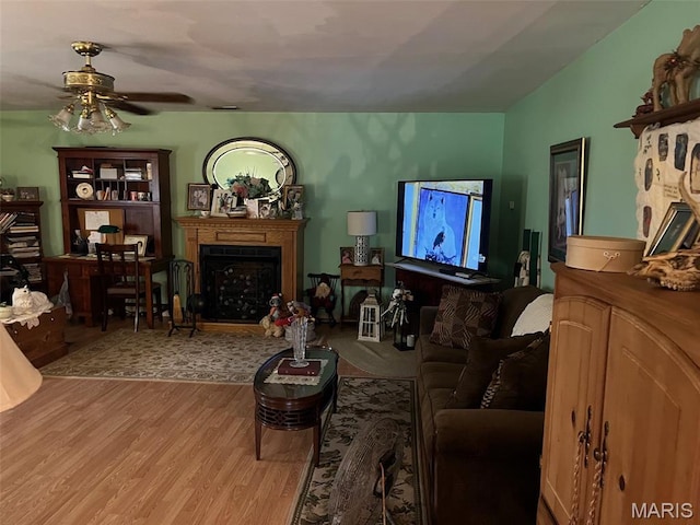 13688 State Highway U, Mineral Point, MO 63660 - living area with a fireplace, wood finished floors, and a ceiling fan
