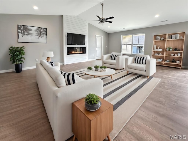 9 Sonata Ln, Troy, IL 62294 - living room featuring ceiling fan, wood finished floors, vaulted ceiling, a large fireplace, and recessed lighting