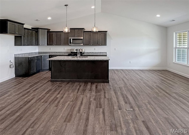 9 Sonata Ln, Troy, IL 62294 - kitchen with appliances with stainless steel finishes, lofted ceiling, an island with sink, dark wood-type flooring, and decorative light fixtures