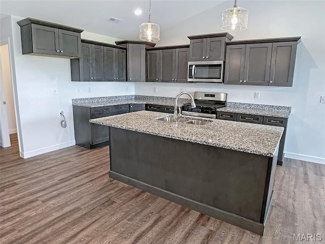 9 Sonata Ln, Troy, IL 62294 - kitchen with stainless steel appliances, light stone counters, dark wood-type flooring, hanging light fixtures, and lofted ceiling