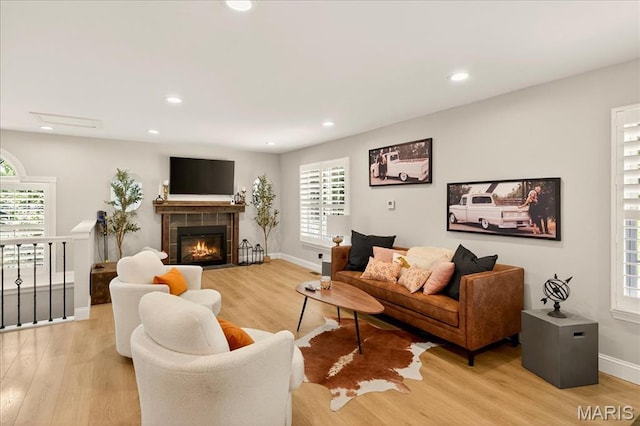 6521 Woodland Dr, Cedar Hill, MO 63016 - living room featuring light wood-style flooring, recessed lighting, and a tiled fireplace