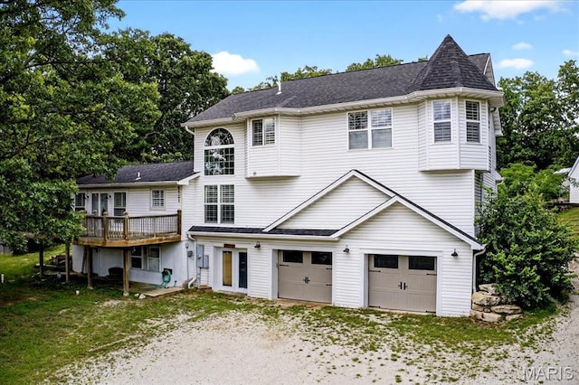 6521 Woodland Dr, Cedar Hill, MO 63016 - view of front of house featuring an attached garage, a deck, dirt driveway, and a shingled roof