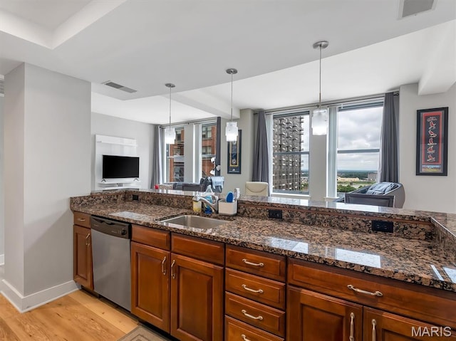 314 N Broadway Unit 1107, Saint Louis, MO 63102 - kitchen featuring dishwasher, light wood-style floors, plenty of natural light, and hanging light fixtures