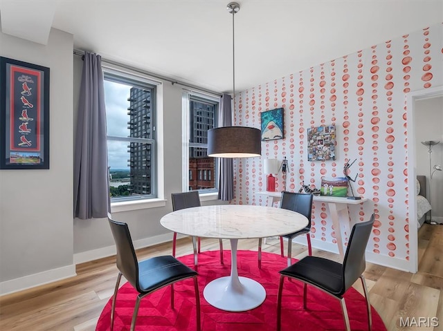 314 N Broadway Unit 1107, Saint Louis, MO 63102 - dining area featuring wood finished floors and wallpapered walls