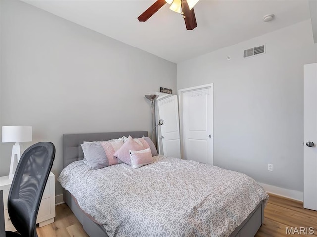 314 N Broadway Unit 1107, Saint Louis, MO 63102 - bedroom with light wood-style floors and a ceiling fan
