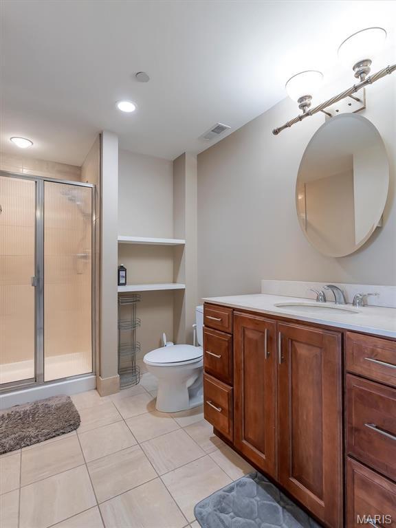314 N Broadway Unit 1107, Saint Louis, MO 63102 - full bathroom featuring vanity, tile patterned flooring, a shower stall, and recessed lighting