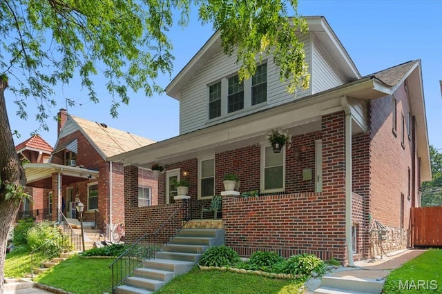 5140 Christy Ave, Saint Louis, MO 63116 - traditional home with brick siding, a porch, and stairway