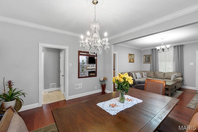 5140 Christy Ave, Saint Louis, MO 63116 - dining space featuring a chandelier, wood finished floors, and crown molding