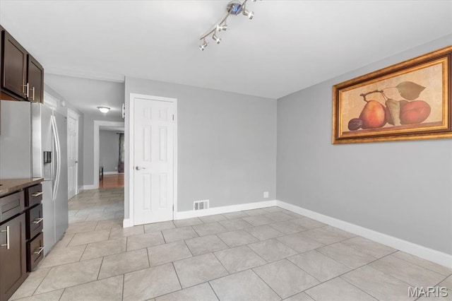5140 Christy Ave, Saint Louis, MO 63116 - spare room featuring light tile patterned flooring and rail lighting
