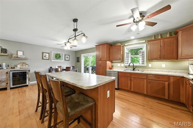 4472 Liberty Ridge Rd, De Soto, MO 63020 - kitchen featuring wine cooler, dishwasher, a ceiling fan, and brown cabinets
