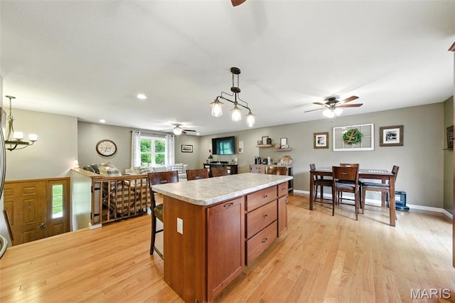 4472 Liberty Ridge Rd, De Soto, MO 63020 - kitchen with a ceiling fan, light countertops, light wood-style floors, and recessed lighting