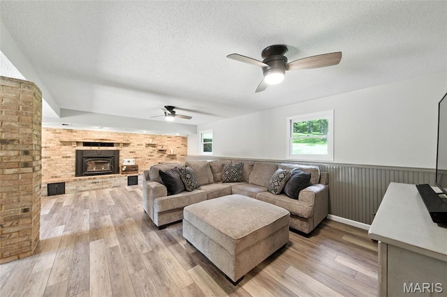 4472 Liberty Ridge Rd, De Soto, MO 63020 - living area with ceiling fan, a textured ceiling, plenty of natural light, light wood-style flooring, and wainscoting