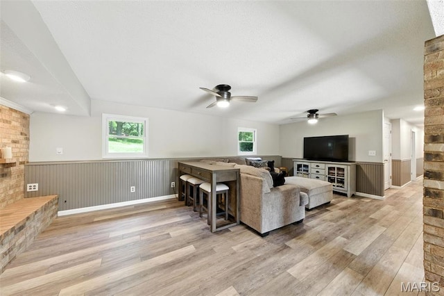4472 Liberty Ridge Rd, De Soto, MO 63020 - living area featuring wood finished floors, a ceiling fan, plenty of natural light, and a wainscoted wall