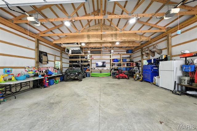 4472 Liberty Ridge Rd, De Soto, MO 63020 - garage featuring freestanding refrigerator and a garage door opener