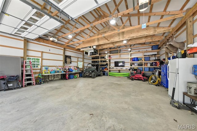 4472 Liberty Ridge Rd, De Soto, MO 63020 - garage with freestanding refrigerator and a garage door opener