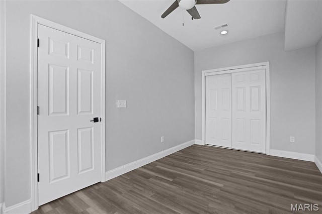 2205 S 11th St, Saint Louis, MO 63104 - unfurnished bedroom with dark wood-style floors, a closet, and a ceiling fan