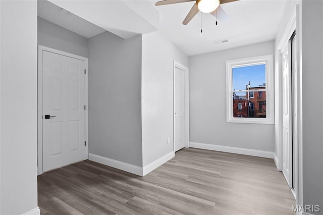2205 S 11th St, Saint Louis, MO 63104 - unfurnished bedroom with wood finished floors and ceiling fan