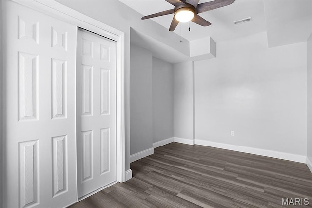 2205 S 11th St, Saint Louis, MO 63104 - unfurnished bedroom with dark wood finished floors, ceiling fan, and a closet