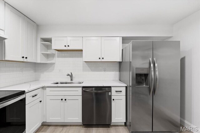 10401 Briarbend Dr Unit 2, Saint Louis, MO 63146 - kitchen with stainless steel appliances, open shelves, light wood-type flooring, light stone counters, and backsplash