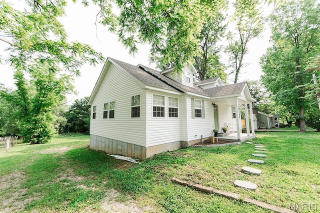 300 E 11th St, Salem, MO 65560 - view of home's exterior featuring a lawn and roof with shingles