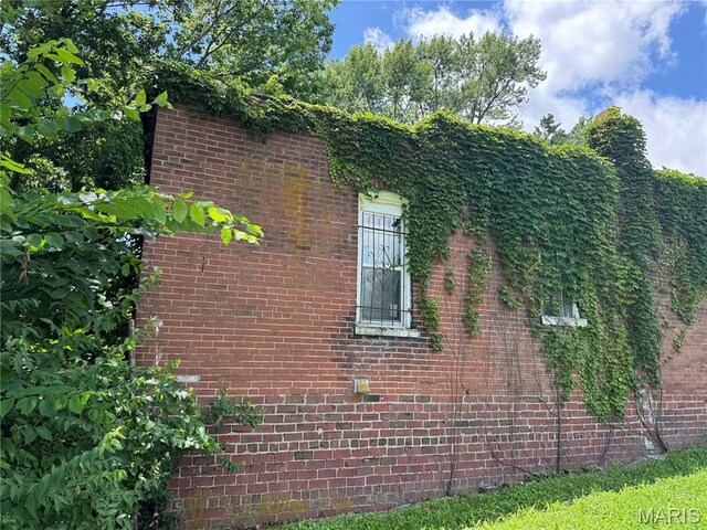view of side of home featuring brick siding