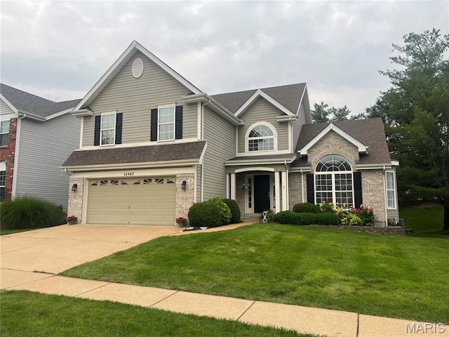 16943 Hickory Forest Ln, Wildwood, MO 63011 - traditional home featuring brick siding, a front lawn, an attached garage, driveway, and a shingled roof