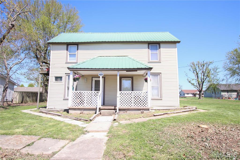 405 E 1st St, Belle, MO 65013 - view of front of house with a porch, a metal roof, and a front yard