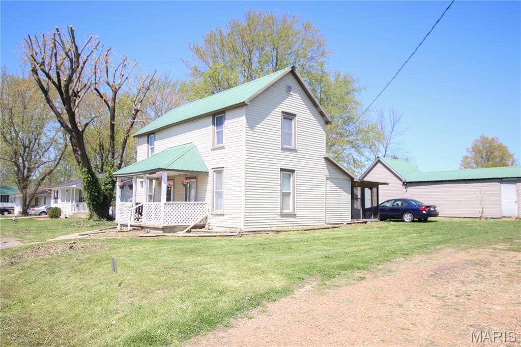 405 E 1st St, Belle, MO 65013 - view of front of house with a front lawn, a porch, and a metal roof