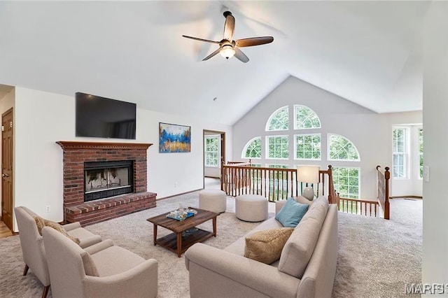 3989 Kim Kelly Dr, Harvester Township, MO 63304 - carpeted living room with ceiling fan, healthy amount of natural light, a fireplace, and high vaulted ceiling