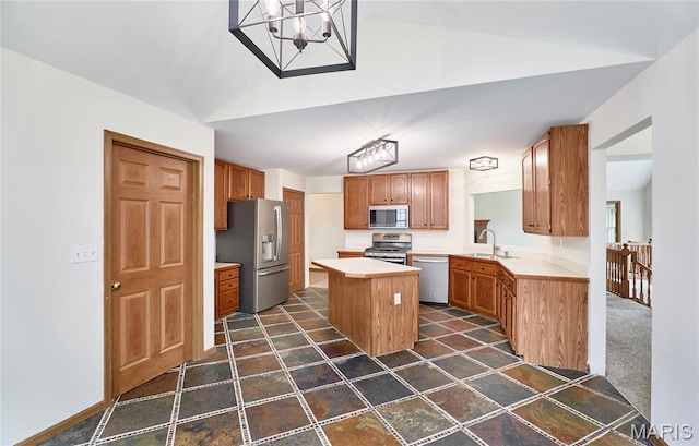 3989 Kim Kelly Dr, Harvester Township, MO 63304 - kitchen with stainless steel appliances, a center island, light countertops, lofted ceiling, and a chandelier