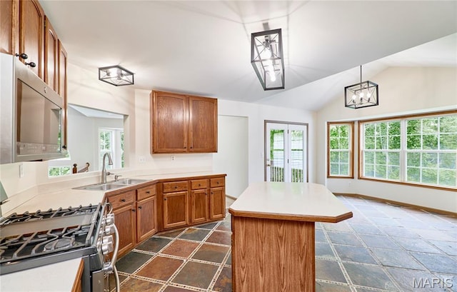 3989 Kim Kelly Dr, Harvester Township, MO 63304 - kitchen featuring stainless steel appliances, a kitchen island, light countertops, lofted ceiling, and brown cabinets