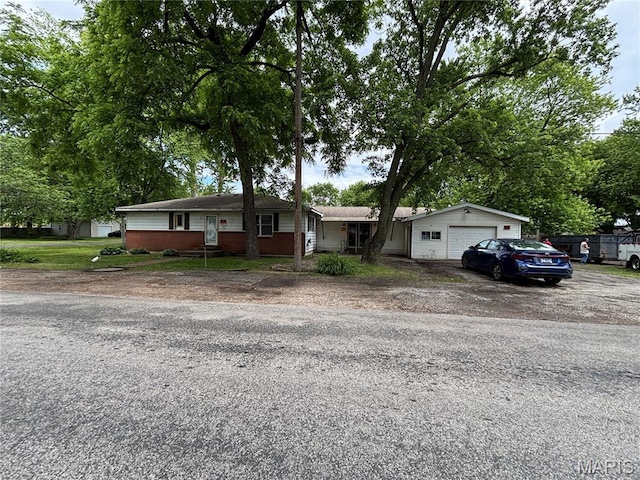 920 N Dye St, Virden, IL 62090 - ranch-style home featuring asphalt driveway, a garage, and brick siding