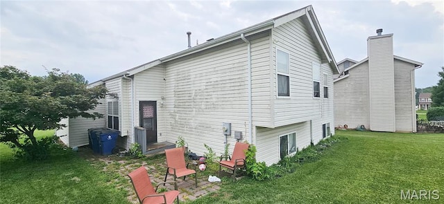 14417 Cape Charles Ct, Florissant, MO 63034 - rear view of property with a yard and a chimney