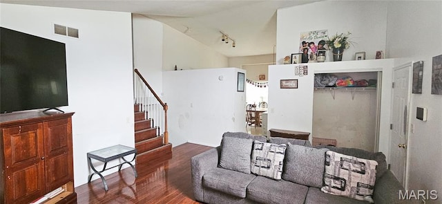 14417 Cape Charles Ct, Florissant, MO 63034 - living area featuring wood finished floors, vaulted ceiling, stairs, and rail lighting