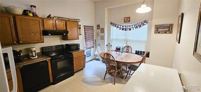 14417 Cape Charles Ct, Florissant, MO 63034 - kitchen featuring black appliances, under cabinet range hood, brown cabinets, and hanging light fixtures
