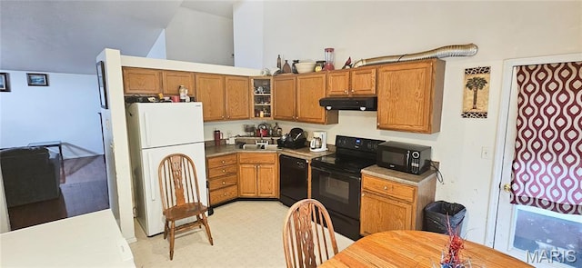 14417 Cape Charles Ct, Florissant, MO 63034 - kitchen featuring black appliances, under cabinet range hood, brown cabinets, glass insert cabinets, and lofted ceiling