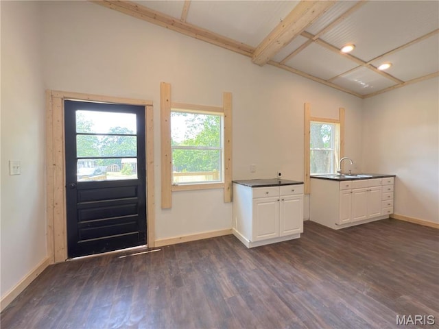 109 Preston St, Crocker, MO 65452 - kitchen with dark wood finished floors, dark countertops, white cabinets, and beamed ceiling