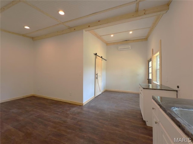 109 Preston St, Crocker, MO 65452 - kitchen with a barn door, dark wood-type flooring, a wall mounted AC, recessed lighting, and white cabinets
