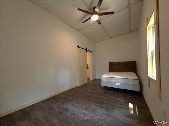 109 Preston St, Crocker, MO 65452 - unfurnished bedroom featuring a barn door, dark wood-style floors, vaulted ceiling, multiple windows, and a ceiling fan